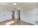 This bedroom includes gleaming wood floors, closet and hallway access, and neutral paint at 4840 Pisgah Rd, Cumming, GA 30028