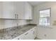 Bright butler's pantry with white cabinets and granite countertops at 4840 Pisgah Rd, Cumming, GA 30028