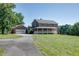Brick home with attached garage and inviting covered porch on a grassy lawn at 4840 Pisgah Rd, Cumming, GA 30028