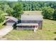 Aerial view of a two-story brick home with a front porch and a detached garage at 4840 Pisgah Rd, Cumming, GA 30028