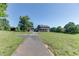 Charming two-story home with a long driveway, lush green lawn, and covered front porch at 4840 Pisgah Rd, Cumming, GA 30028