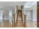 Open foyer with hardwood floors, staircase, and views into adjacent rooms at 4840 Pisgah Rd, Cumming, GA 30028