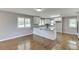 Open kitchen featuring granite countertops, white cabinets, and stainless appliances at 4840 Pisgah Rd, Cumming, GA 30028