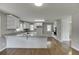 Bright kitchen featuring granite countertops, white cabinets, and stainless appliances at 4840 Pisgah Rd, Cumming, GA 30028