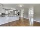 Open kitchen featuring granite countertops, white cabinets, and stainless appliances at 4840 Pisgah Rd, Cumming, GA 30028
