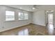Well-lit living room with hardwood floors, a ceiling fan, and natural light at 4840 Pisgah Rd, Cumming, GA 30028