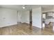 Open-concept living room with hardwood floors that connects to the kitchen at 4840 Pisgah Rd, Cumming, GA 30028