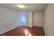 A bright bedroom with hardwood floors and natural light pouring through the windows at 553 Rockbridge Trl, Stone Mountain, GA 30083