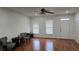 Spacious living room featuring hardwood floors and neutral paint at 553 Rockbridge Trl, Stone Mountain, GA 30083