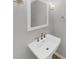 Elegant half-bath featuring a pedestal sink, brushed bronze faucet, and modern fixtures at 1110 Robert Pointe Way, Lawrenceville, GA 30045