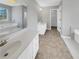 Spacious bathroom featuring double sinks, a soaking tub, and modern fixtures at 1110 Robert Pointe Way, Lawrenceville, GA 30045
