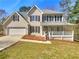 Charming two-story home with a welcoming front porch and a two-car garage, set on a well-maintained lawn at 1110 Robert Pointe Way, Lawrenceville, GA 30045