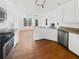Bright, open kitchen with stainless steel appliances, granite countertops, and wood floors at 1110 Robert Pointe Way, Lawrenceville, GA 30045