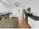 Well-lit kitchen featuring stainless steel appliances, granite counters, wood floors and white cabinets at 1110 Robert Pointe Way, Lawrenceville, GA 30045