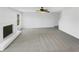 Spacious living room with gray carpet, a white fireplace, ceiling fan and lots of natural light at 1110 Robert Pointe Way, Lawrenceville, GA 30045