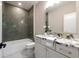 Stylish bathroom with a tub and shower featuring sleek tiles and a marble-topped vanity at 1442 Cedarhurst Dr, Dunwoody, GA 30338