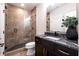 Modern bathroom featuring dark cabinets, granite countertop, glass enclosed shower, and unique fixtures at 1442 Cedarhurst Dr, Dunwoody, GA 30338