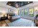 Serene bedroom with tray ceiling, a large window, and hardwood floors and area rug at 1442 Cedarhurst Dr, Dunwoody, GA 30338