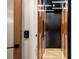 Modern hallway featuring wood paneling, recessed lighting, and a minimalist design at 1442 Cedarhurst Dr, Dunwoody, GA 30338