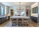 Spacious kitchen featuring an island with seating, pendant lighting, custom cabinets, and stainless steel appliances at 1442 Cedarhurst Dr, Dunwoody, GA 30338