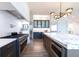 Open kitchen design with stainless steel appliances, marble countertops, and modern lighting at 1442 Cedarhurst Dr, Dunwoody, GA 30338
