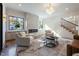 Inviting living room with a modern fireplace, hardwood floors, stylish furniture, and lots of natural light at 1442 Cedarhurst Dr, Dunwoody, GA 30338