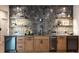 Modern wet bar features tile backsplash, granite countertops, wine cooler and floating shelves at 1442 Cedarhurst Dr, Dunwoody, GA 30338