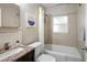 Cozy bathroom featuring a granite-topped sink and a shower-tub combo at 1584 Carroll Nw Dr, Atlanta, GA 30318