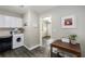 Modern kitchen area with a breakfast table, ample countertop space, and adjacent laundry hookups at 1584 Carroll Nw Dr, Atlanta, GA 30318