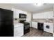 Bright kitchen with modern appliances, white cabinets, and a convenient washer/dryer setup for easy chores at 1584 Carroll Nw Dr, Atlanta, GA 30318