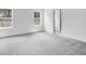 A spacious bedroom with plush gray carpeting and natural light from two windows at 205 Groveton Ct, Euharlee, GA 30145