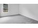Cozy bedroom with plush gray carpeting, a window, and freshly painted white walls at 205 Groveton Ct, Euharlee, GA 30145
