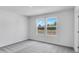 Bright bedroom featuring neutral walls, plush carpeting, and natural light streaming through double windows at 205 Groveton Ct, Euharlee, GA 30145