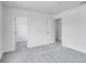 Spacious bedroom with soft carpeting, bright white walls, and open doorway to closet at 205 Groveton Ct, Euharlee, GA 30145
