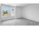 Well-lit bedroom with plush gray carpet and natural light from the expansive windows at 205 Groveton Ct, Euharlee, GA 30145