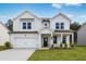 Charming two-story home boasts a modern design, manicured lawn, and inviting front porch at 205 Groveton Ct, Euharlee, GA 30145