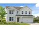 Charming two-story home with white brick, landscaped yard, and attached two-car garage at 205 Groveton Ct, Euharlee, GA 30145