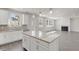 Spacious kitchen open to the living room featuring white cabinets, granite countertops and wooden floors at 205 Groveton Ct, Euharlee, GA 30145