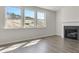 Bright living room featuring a fireplace and hardwood floors and three large windows at 205 Groveton Ct, Euharlee, GA 30145