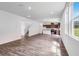 Open-concept living room flows seamlessly into the kitchen, featuring sleek floors and natural light at 205 Groveton Ct, Euharlee, GA 30145