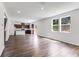 Open-concept living room flows into the kitchen, with abundant natural light and modern flooring at 205 Groveton Ct, Euharlee, GA 30145