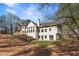 Backyard with wooden deck, stairs to the lower level, and view to the woods at 2410 Glade Overlook, Cumming, GA 30041