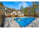 Backyard with pool, fence, and wooden deck at 2410 Glade Overlook, Cumming, GA 30041