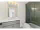 Bathroom featuring gray vanity and tiled shower with glass doors at 2410 Glade Overlook, Cumming, GA 30041