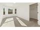 Bright bedroom with three windows, a walk-in closet, and neutral carpet at 2410 Glade Overlook, Cumming, GA 30041
