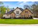 Charming two-story home featuring stone and brick accents, complemented by a well-manicured lawn and mature trees at 2410 Glade Overlook, Cumming, GA 30041