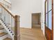 Bright foyer features hardwood floors, a stairway, and doorway view to a room with wainscoting at 2410 Glade Overlook, Cumming, GA 30041