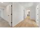 Hallway with wainscoting, wood floors, and white doors at 2410 Glade Overlook, Cumming, GA 30041