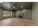 Comfortable living room featuring hardwood floors, a fireplace and a view to the trees outside at 2410 Glade Overlook, Cumming, GA 30041