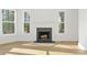 Living room featuring a fireplace, and bright windows overlooking trees at 2410 Glade Overlook, Cumming, GA 30041